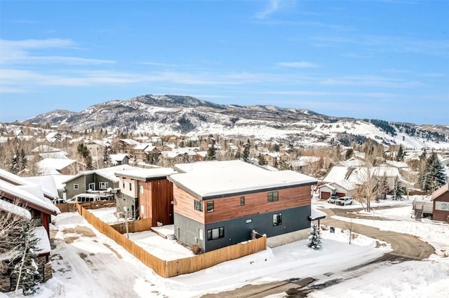 snowy aerial view featuring a mountain view