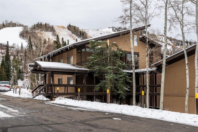 view of snow covered exterior featuring a mountain view