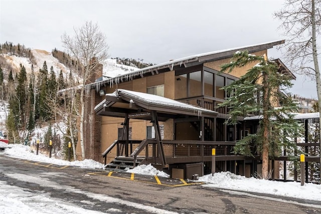 snow covered property with a mountain view