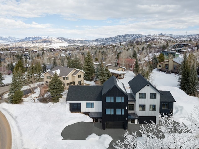 snowy aerial view featuring a mountain view