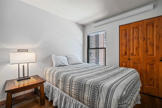 bedroom with dark wood-type flooring