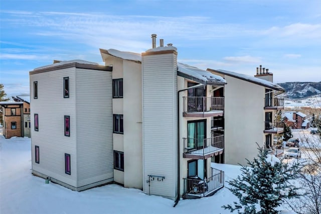 snow covered property featuring a mountain view