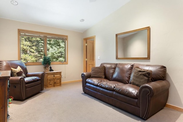 living room with light colored carpet and lofted ceiling