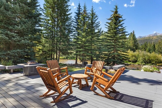 wooden terrace with an outdoor fire pit