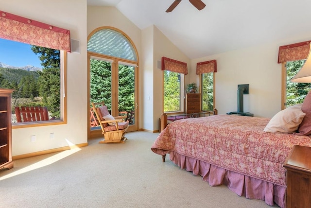 carpeted bedroom featuring high vaulted ceiling and ceiling fan