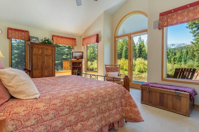 carpeted bedroom featuring ceiling fan and high vaulted ceiling