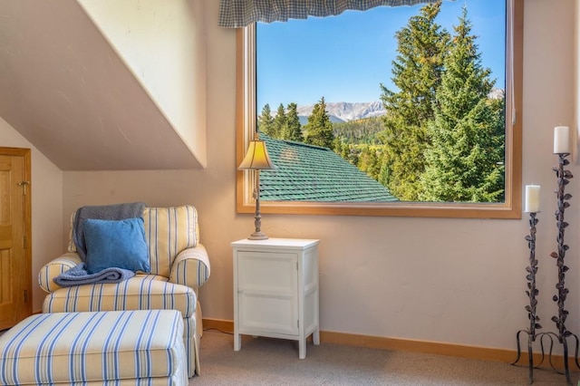 sitting room featuring carpet and a mountain view