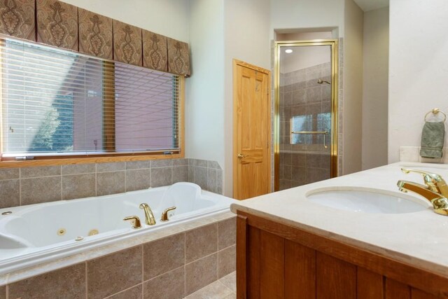 bathroom featuring vanity and independent shower and bath