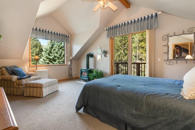 carpeted bedroom with ceiling fan, lofted ceiling with beams, a wood stove, and access to outside