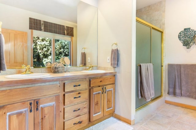 bathroom featuring tile patterned flooring, vanity, and walk in shower