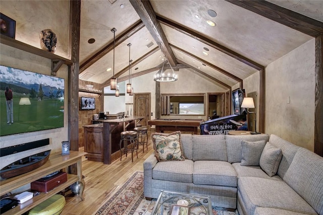 living room featuring light wood-type flooring, lofted ceiling with beams, and a chandelier