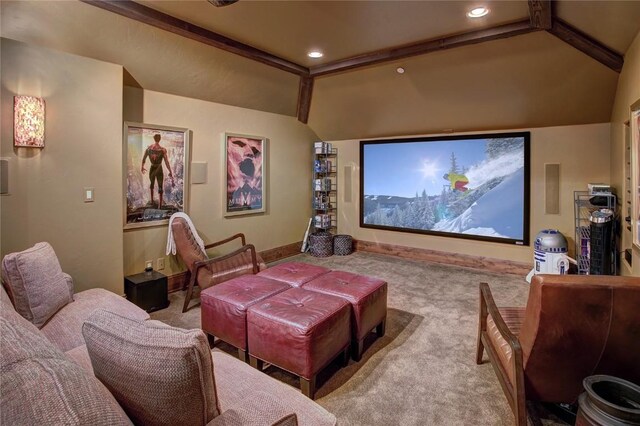 carpeted cinema with lofted ceiling with beams