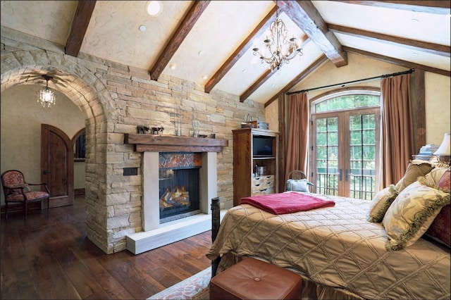 bedroom featuring french doors, a notable chandelier, vaulted ceiling with beams, dark hardwood / wood-style floors, and a stone fireplace