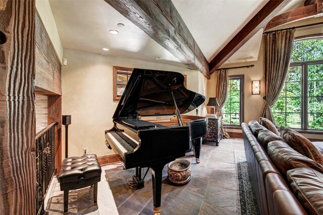 misc room with vaulted ceiling with beams