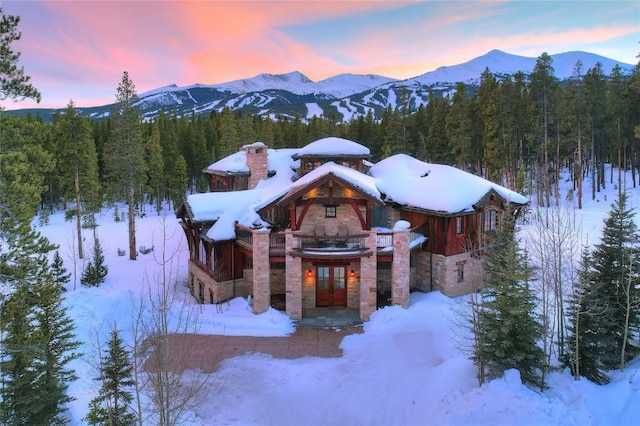 exterior space with a mountain view and french doors