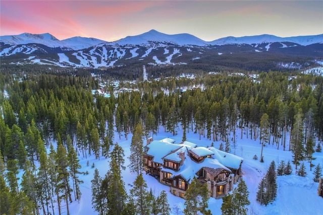 snowy aerial view featuring a mountain view