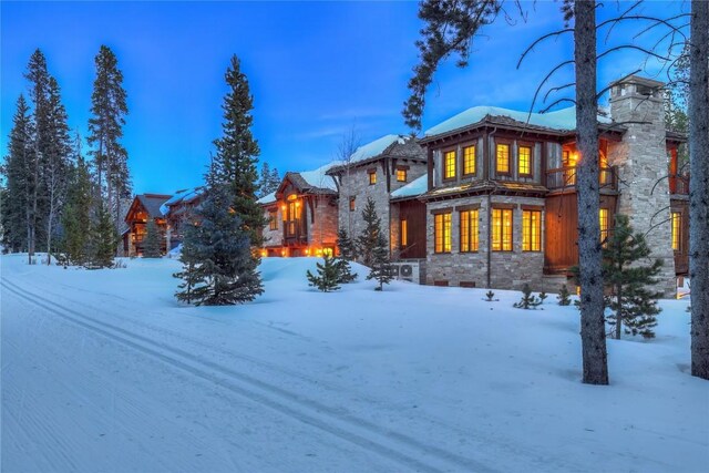 view of snow covered back of property