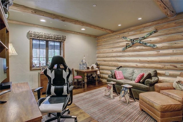 office with beam ceiling, rustic walls, and hardwood / wood-style floors