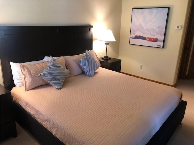 carpeted bedroom with baseboards