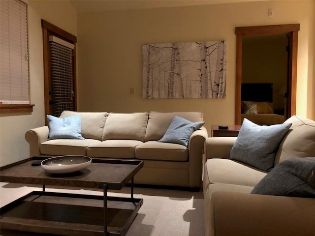 living area with baseboards and carpet