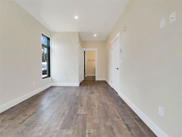 empty room with dark wood-type flooring