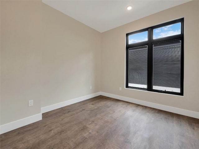 spare room with hardwood / wood-style floors