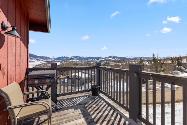 snow covered deck featuring a mountain view