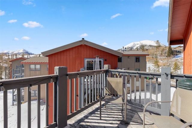 snow covered deck featuring a mountain view