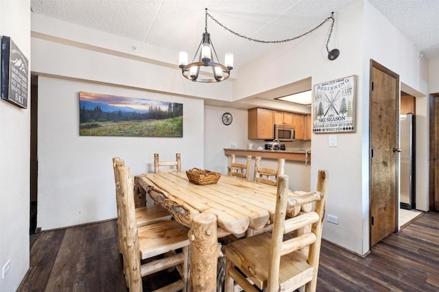 dining area featuring an inviting chandelier, dark hardwood / wood-style floors, and a textured ceiling