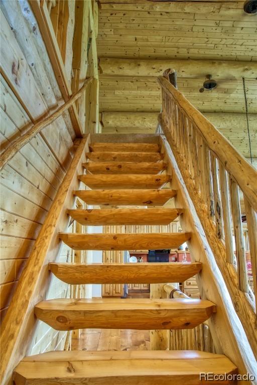 stairway with wooden ceiling