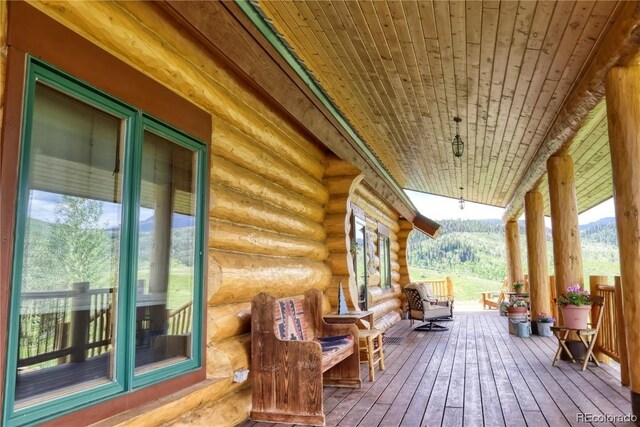 deck with a mountain view and a porch