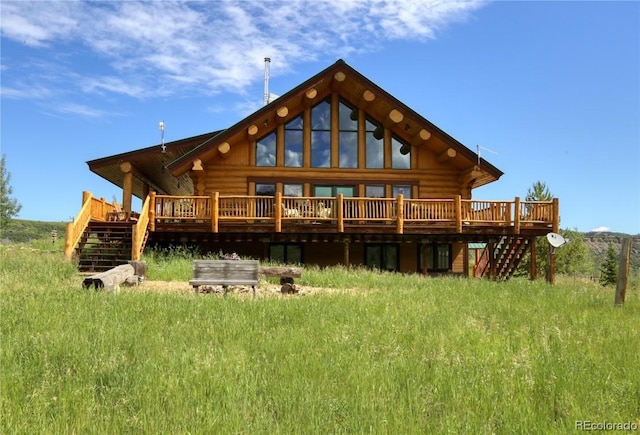 rear view of property featuring a wooden deck