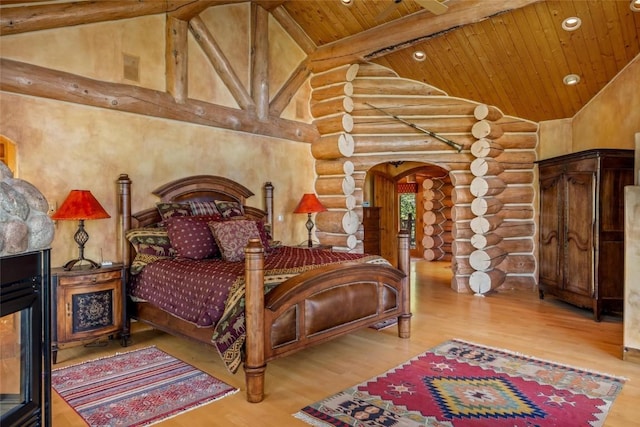 bedroom with hardwood / wood-style flooring, beam ceiling, high vaulted ceiling, and wooden ceiling