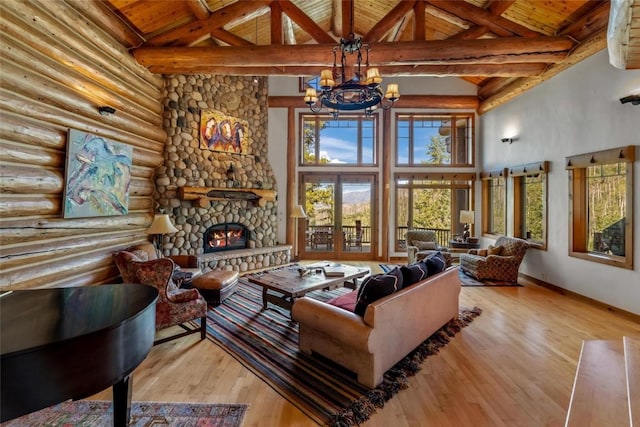 living room featuring an inviting chandelier, light hardwood / wood-style floors, high vaulted ceiling, and beamed ceiling