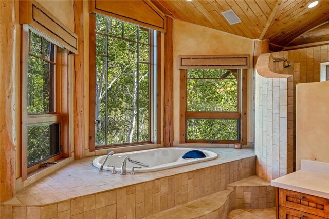 bathroom featuring tiled tub, lofted ceiling, and wooden ceiling