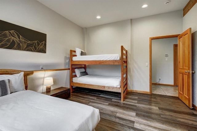 bedroom with dark wood-type flooring