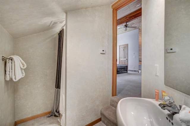 bathroom featuring ceiling fan, sink, and tile patterned flooring