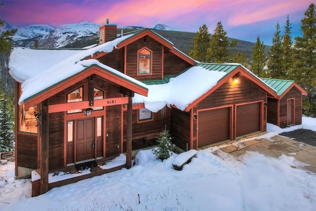 log-style house with a mountain view and a garage