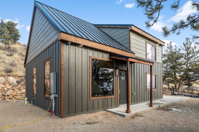 view of home's exterior featuring board and batten siding, a standing seam roof, and metal roof