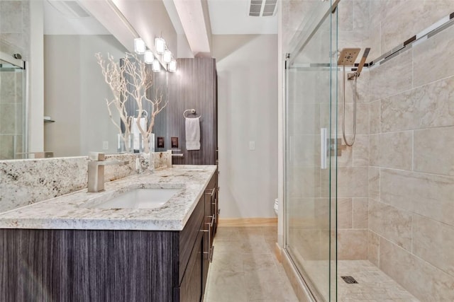 bathroom with toilet, a shower with shower door, a notable chandelier, and vanity