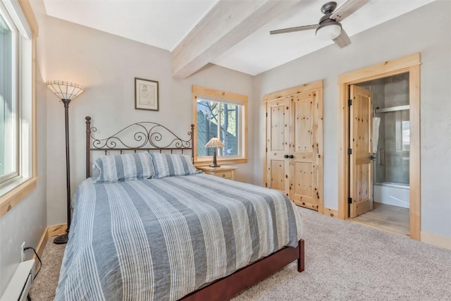 carpeted bedroom featuring ceiling fan, connected bathroom, beam ceiling, and baseboard heating