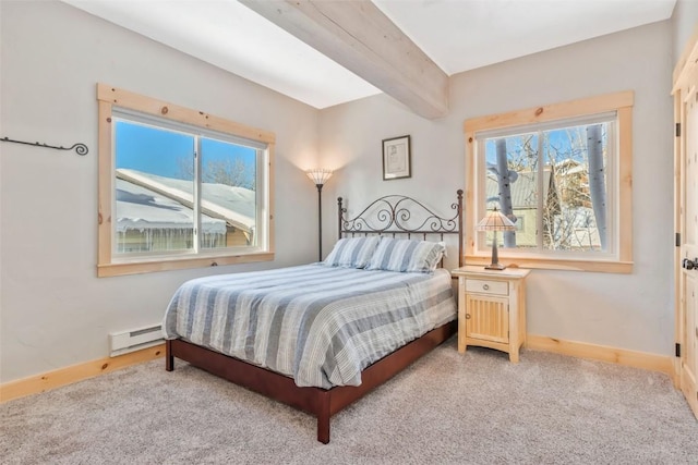 carpeted bedroom with a baseboard heating unit and beam ceiling