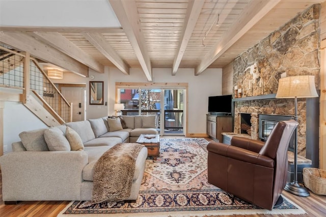 living room with wood ceiling, wood-type flooring, beamed ceiling, and a fireplace