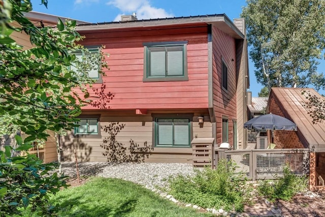 rear view of property featuring a garage