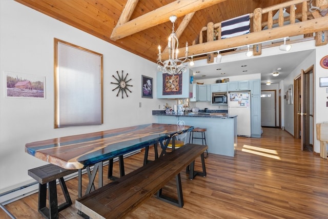 dining room with wood finished floors, beam ceiling, a baseboard heating unit, wooden ceiling, and a notable chandelier