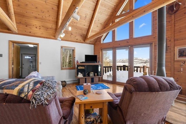 living room featuring beamed ceiling, high vaulted ceiling, track lighting, wood finished floors, and wooden ceiling