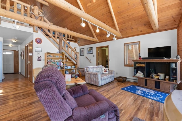 living room with beamed ceiling, stairway, wood ceiling, and wood finished floors