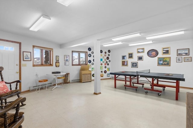 game room featuring tile patterned floors, a baseboard heating unit, and baseboards