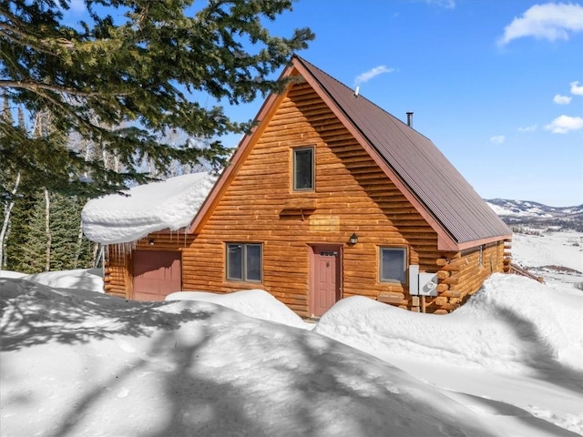 log home with a garage and log exterior