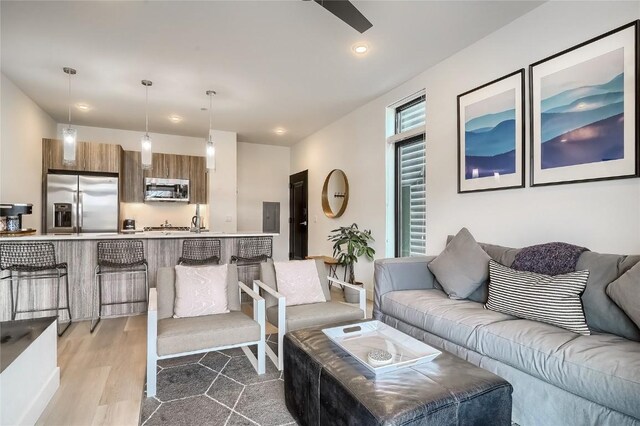 living room with light hardwood / wood-style floors and electric panel